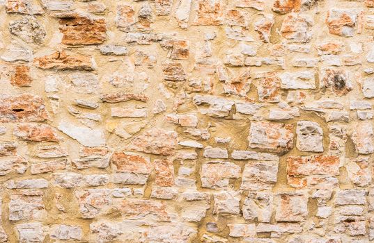 Natural old stone wall background texture, close-up