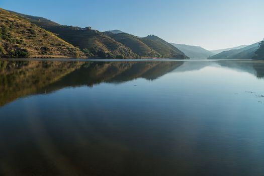 Scenic view of the Douro Valley and river with terraced vineyards near the village of Tua, Portugal