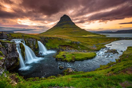 Iceland waterfall and famous mountain. Kirkjufellsfoss and Kirkjufell in northern Iceland nature landscape.