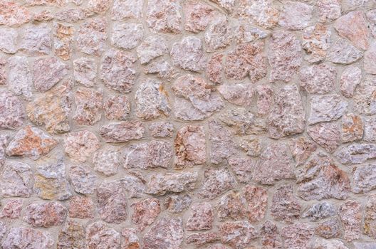 Grey stone wall background texture, close up