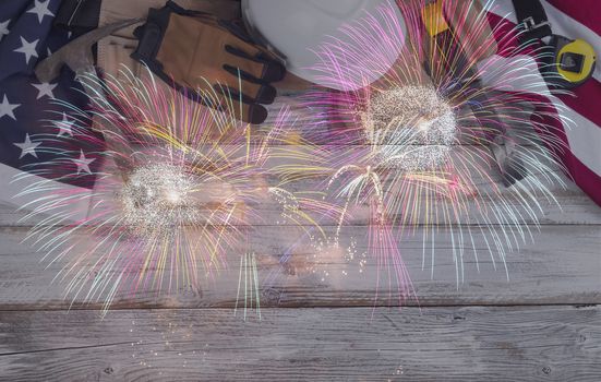 US Happy Labor Day concept with top border consisting of national flag and leather pouch containing industrial work tools on white rustic wooden background plus fireworks