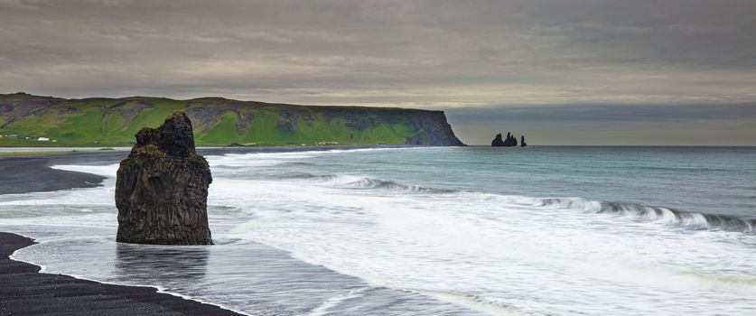ICELAND LANDSCAPE: Reynisfjara Beach view point Dyrholaey. Famous Iceland black sand beach on South Iceland. Icelandic nature landscape tourist attraction destination.