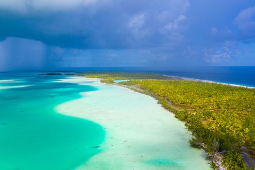 French Polynesia Tahiti aerial drone view of Fakarava atoll and famous Blue Lagoon and motu island with perfect beach, coral reef and Pacific Ocean. Tropical travel paradise in Tuamotus Islands.