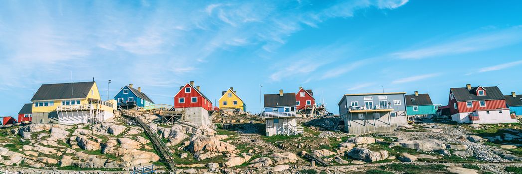 Greenland view of houses in Ilulissat City and icefjord. Tourist destination in the actic. Panoramic photo of typical Greenland village houses.