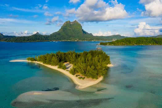 Bora Bora in French Polynesia. Aerial view of Motu Tapu paradise island and turquoise blue water in coral reef lagoon and Mt Pahia, Mount Otemanu, Tahiti, South Pacific Ocean.