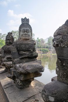  Angkor Wat Temple Cambodia - March 2018: Stone Asura at bridge leading into the 12th century city of Angkor Thom. 
