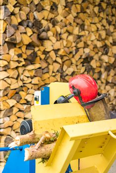 Prepairing sawing tree trunks with circular saw as firewood