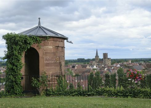 France, Alsace, June 2015: Stone tower and doorway in turret overlooking medieval village and church