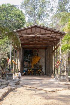 Cambodia, Angkor Thom - March 2016: Ancient Buddha statues have been re-covered with decorative roofs and are still used by the local population as place as worship within the Angkor Thom complex