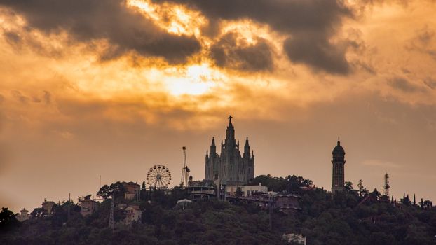 Spain, Barcelona - June 2018: Sunset over Barcelona's Tibidabo Amusement Park