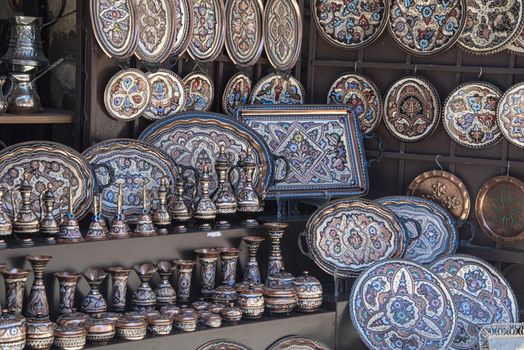 Bosnia and Herzegovina, Mostar - June 2018: Decorative enamelled plates on sale to tourists at a local street bazaar