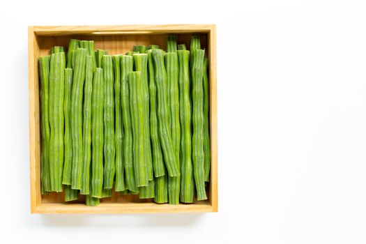 Moringa oleifera in wooden box isolated on white background.