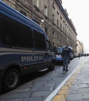 TURIN, ITALY - CIRCA OCTOBER 2019: police van and officer in Via Verdi