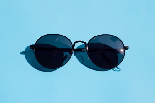 Sunglasses on blue background. Enjoy holiday concept. Copy space