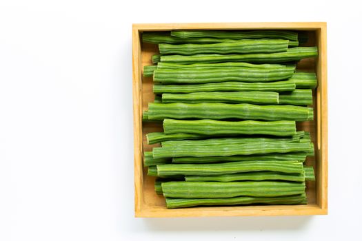 Moringa oleifera in wooden box isolated on white background.