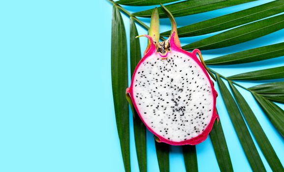 Ripe dragonfruit or pitahaya on tropical palm leaves. Top view