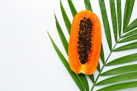 Sweet ripe papaya on tropical palm leaves. Top view