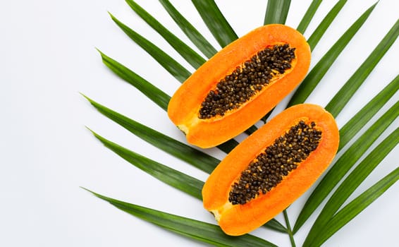 Sweet ripe papaya on tropical palm leaves. Top view