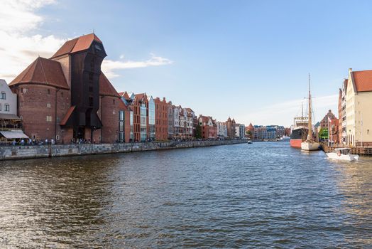 View of New Motlawa river in Gdansk downtown with historic port crane