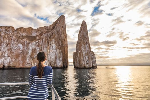 Galapagos Cruise ship tourist on boat looking at Kicker Rock nature landscape. Iconic landmark and tourist destination for birdwatching, diving and snorkeling, San Cristobal Island, Galapagos Islands.