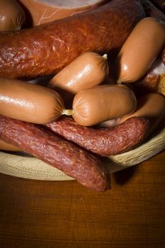 Set of various sausages in a wooden plate