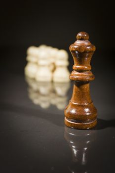 Chess pieces on a black reflective surface