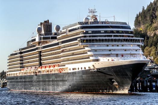 Vacation travel cruise ship at port of call harbor destination in Alaska, USA at sunset.