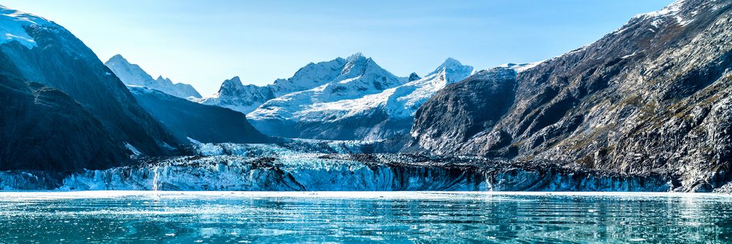 Panoramic view in Glacier Bay from cruise ship cruising towards Johns Hopkins Glacier in summer in Alaska, USA. Banner panorama crop.