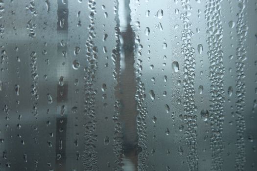 Bright grey color glassy texture, with water drops on it. Water drop glassy background