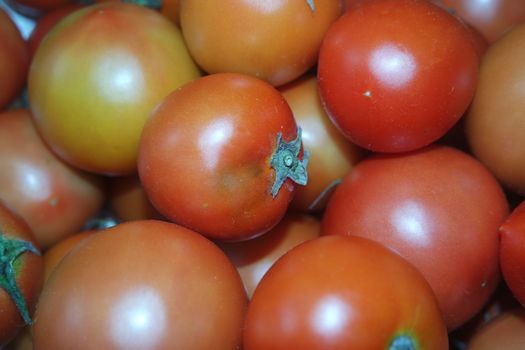 Close-up view of red tomatoes in market for sale. A fruit background for text and advertisements