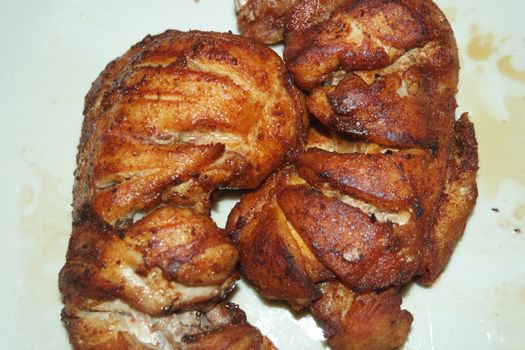 Fried, grilled baked chicken pieces with marinated spices on it. Tasty delicious fried chicken barbecue