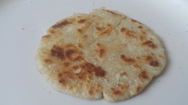 Closeup view of of traditional bread called Jawar roti or bhakri on white background. Bhakri is a round flat unleavened bread often used in the cuisine of many Asian countries