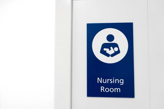 A sign at the entrance to the baby nursing room. Feeding and swaddling children in a public place