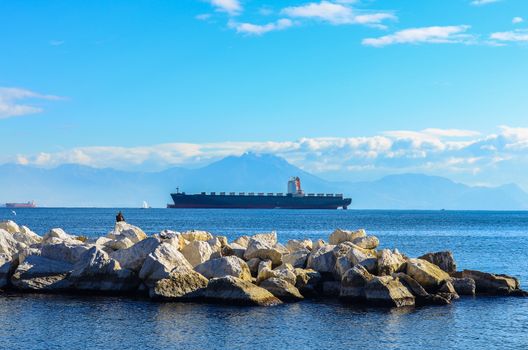 stones and cargo ship (ocean tanker) in the sea near the port