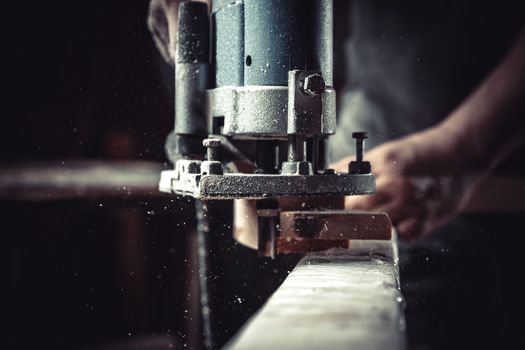 detail of electric milling cutter in joinery during wood milling.