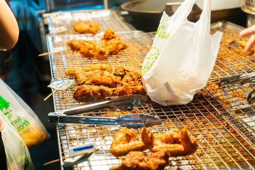 Counter sells chicken in batter at asia food night market.