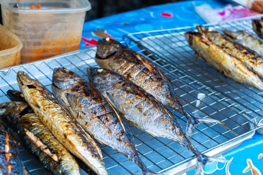 Grilled fish on the counter. Street food. in Asia.