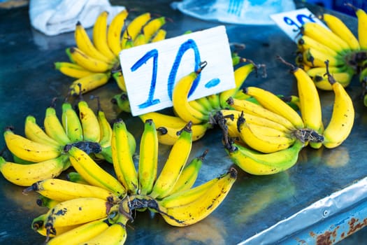 A counter with branches of yellow bananas