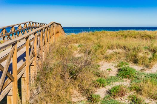 Wooden boardwalk to the beach at the bay of Alcudia, Mallorca Spain
