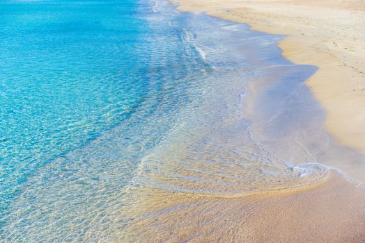 Close-up of shoreline on sand beach with beautiful turquoise colored sea water