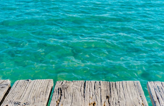 Soft sea wave water and wooden pier background