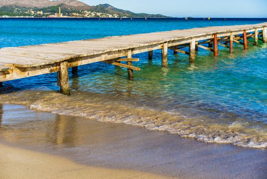 View of wooden pier at the bay of Alcudia, Spain Balearic islands