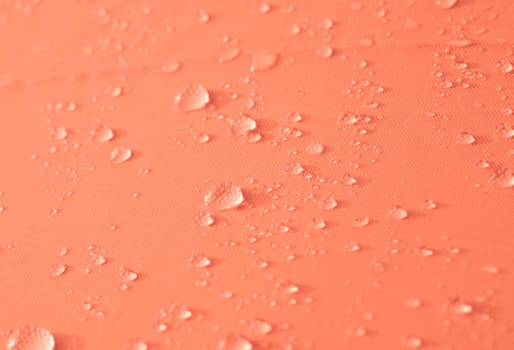 Drops of water or rain drop on orange background.