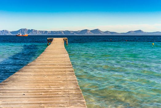 Wooden jetty at the bay of Alcudia on Majorca island, Spain Mediterranean Sea