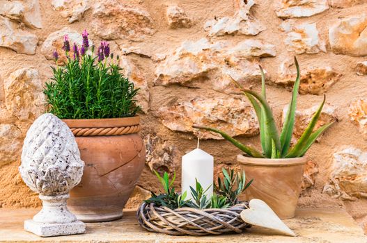 Idyllic provence mediterranean garden decoration with rustic stone wall background