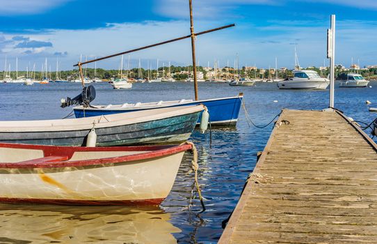 Harbour bay with anchoring boats an wooden jetty