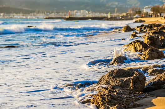 Foamy waves on rocky beach coastline

