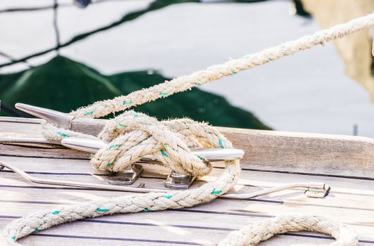 Detail view of yacht rope cleat on sailboat deck