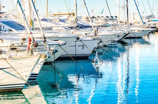 View of many luxury yachts boats moored in mediterranean harbor