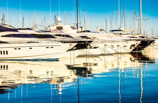 View of luxury motor yachts moored in marina, maritime nautical background